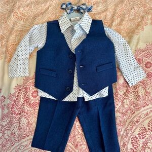 This is a boys 4-piece suit (shirt, pants, vest, and bow tie)  by Van Heusen.
